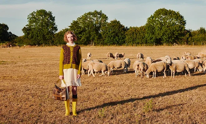 Orla Kiely leather bag carried in a field of sheep